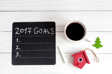 notebook and goals for new year wooden background top view