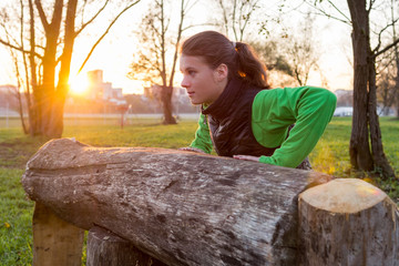 Attractive brunette working out in a park.