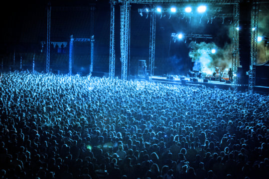 Blurred Image of Huge Crowd of People at Music concert, in blue