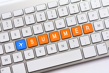 SUMMER writing on white keyboard with a aircraft sketch