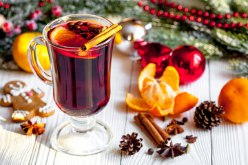 Christmas mulled wine with spices in cup on wooden background