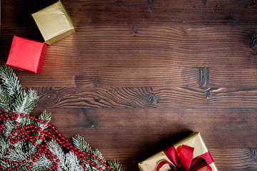 packaging christmas gifts in boxes on wooden background top view