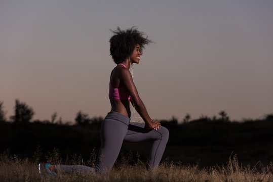 black woman is doing stretching exercise relaxing and warm up