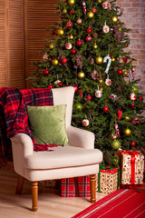 Beautiful holiday decorated room with Christmas tree and gifts. Cozy New Year home interior.