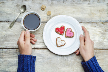 Male hands holding cookie in the forms of heart