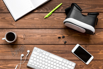 virtual reality glasses on mans working desktop top view