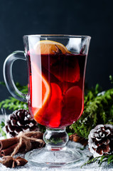 Mulled wine and spices on wooden background.