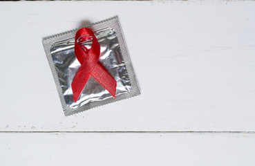 Red ribbon with a condom 