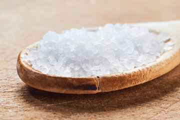 Fototapeta na wymiar Sea salt in a wooden spoon
