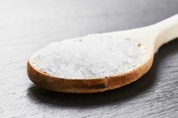 Fototapeta na wymiar Sea salt in a wooden spoon