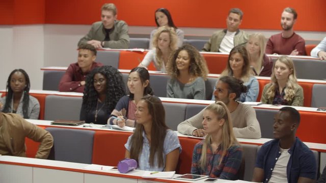 Teacher addressing students in a university lecture theatre