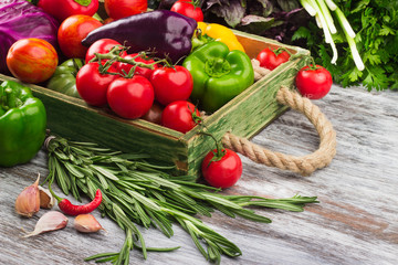Set of raw vegetables in the wooden tray