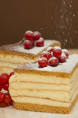 Pieces puff cheesecake decorated with icing sugar