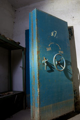 Blue rusty hermetical door of old abandoned Soviet bomb shelter 