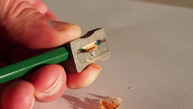 green colored pencil and pencil sharpener 