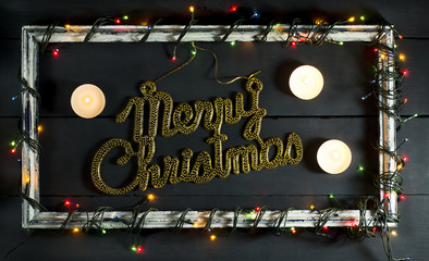 Glowing Christmas tree garland on old frame with decorations