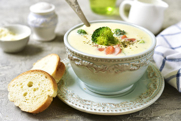 Vegetable chowder with cheese in a blue vintage bowl.
