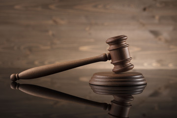 law theme, mallet of the judge, justice scale, hourglass, books, wooden background