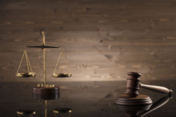 law theme, mallet of the judge, justice scale, hourglass, books, wooden background