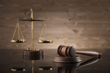 law theme, mallet of the judge, justice scale, hourglass, books, wooden background