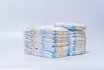 pile of disposable diapers in a stack on a white background