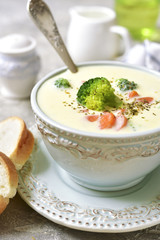 Vegetable chowder with cheese in a blue vintage bowl.