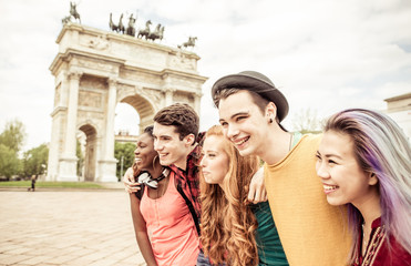 Group of four friends laughing out loud outdoor, sharing good an