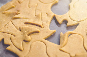 Abstract Christmas food background with cookies molds and flour. Baking Christmas cookies - table, cookie cutters and cookies.