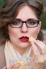 woman eating  sweet candy, toffee caramel