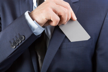 Businessman in suit holding blank card with YOUR TEXT OR IMAGE