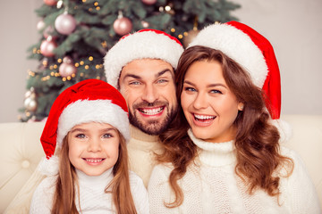 Portrait of lovely pretty smiling family wearing santa hats