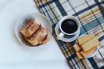 Breakfast with coffee, cookies, waffles and plaid. Instagram toned photo.