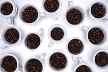 Group of coffee cup with roasted beans top view on metallic grey background
