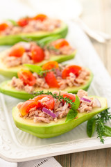 Stuffed avocado on tray.