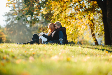 young family and newborn son in autumn park