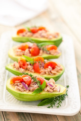 Stuffed avocado on tray.