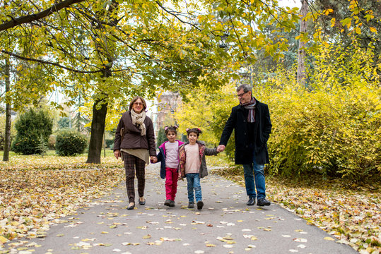 Grandparents with grandchildren in autumn park
