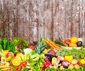 Obraz na płótnie Canvas Vegetables and fruits over dark wall background.