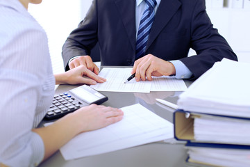 Bookkeepers or financial inspector making report, calculating or checking balance. Audit concept.