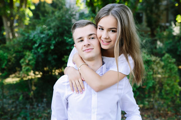 Fototapeta premium Young adult brunette man and woman in the park