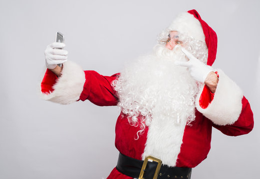 Santa Claus makes a selfie on white background