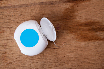 Dental floss isolated on wood board