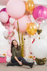 Young pretty woman with pink balloons