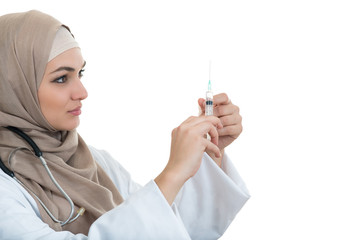 Muslim female medical doctor filling the syringe getting ready for a medical procedure.