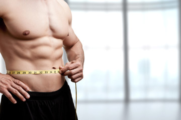Fit Man Measuring His Waist