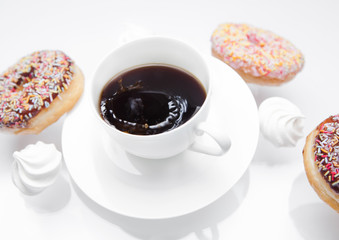 Cup of coffee with donuts and meringues in motion
