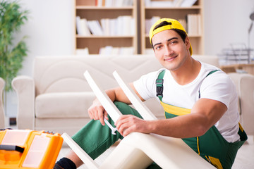 Furniture repairman repairing armchair at home