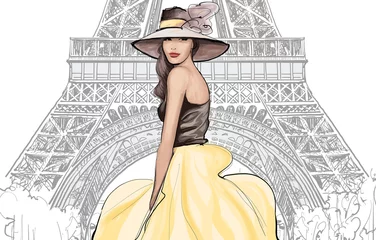 Wall murals Art Studio Young pretty fashion model with hat in Paris