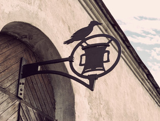 Old medieval wrought iron sign on the door