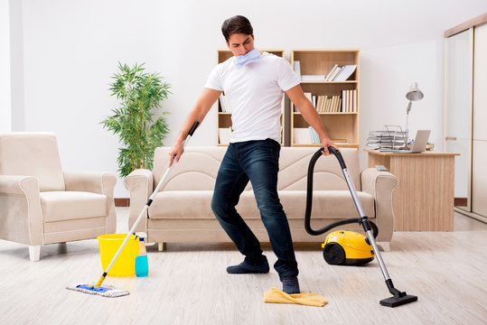 Man cleaning home with vacuum cleaner